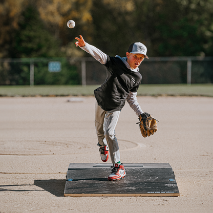 Up and coming young pitcher training on a FirstStrike Wheeled 6-Inch portable Pitching Mound.